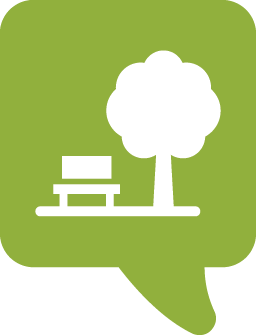 green speech bubble with a white bench and tree