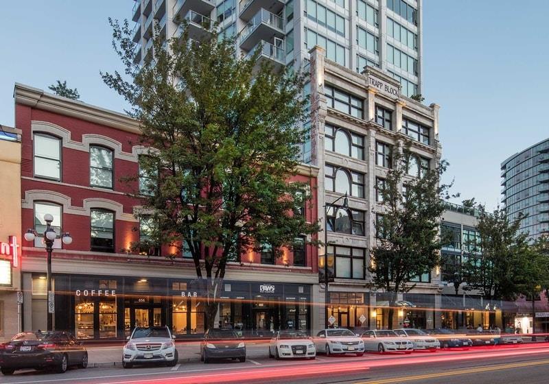 Photo of shops and parked cars along a street