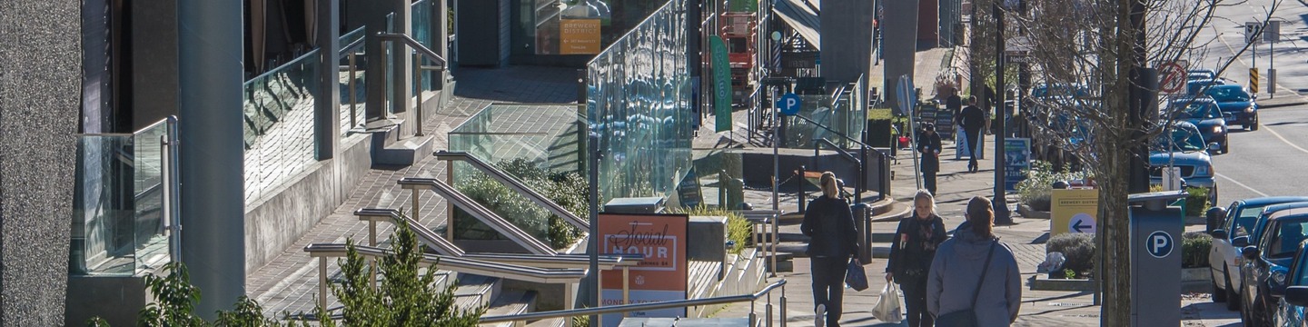Photo of people walking along a sidewalk