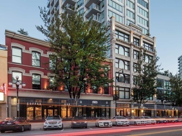 Photo of shops and parked cars along a street
