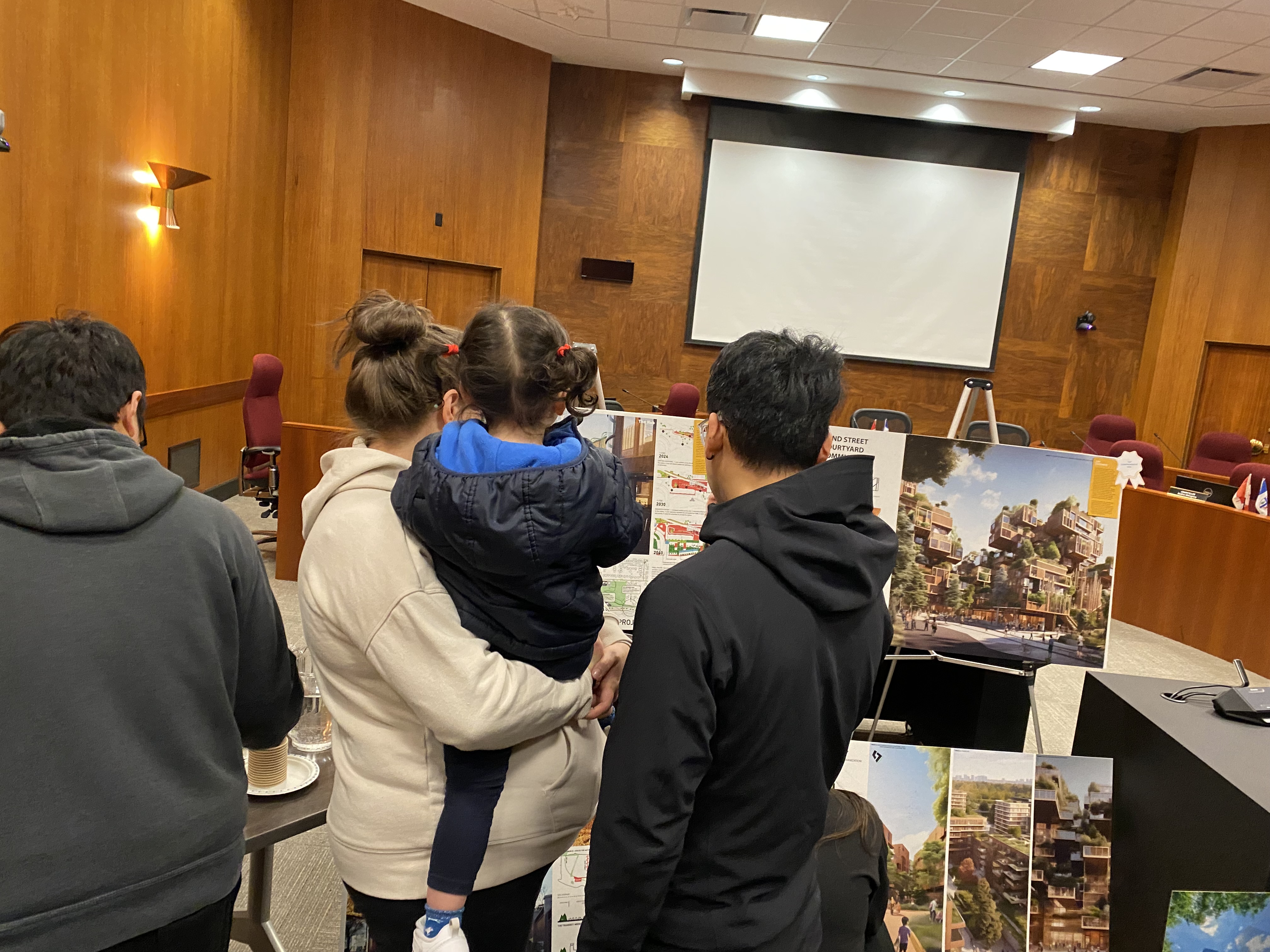 Attendees view the information boards of reGENERATE Ideas Challenge winners.