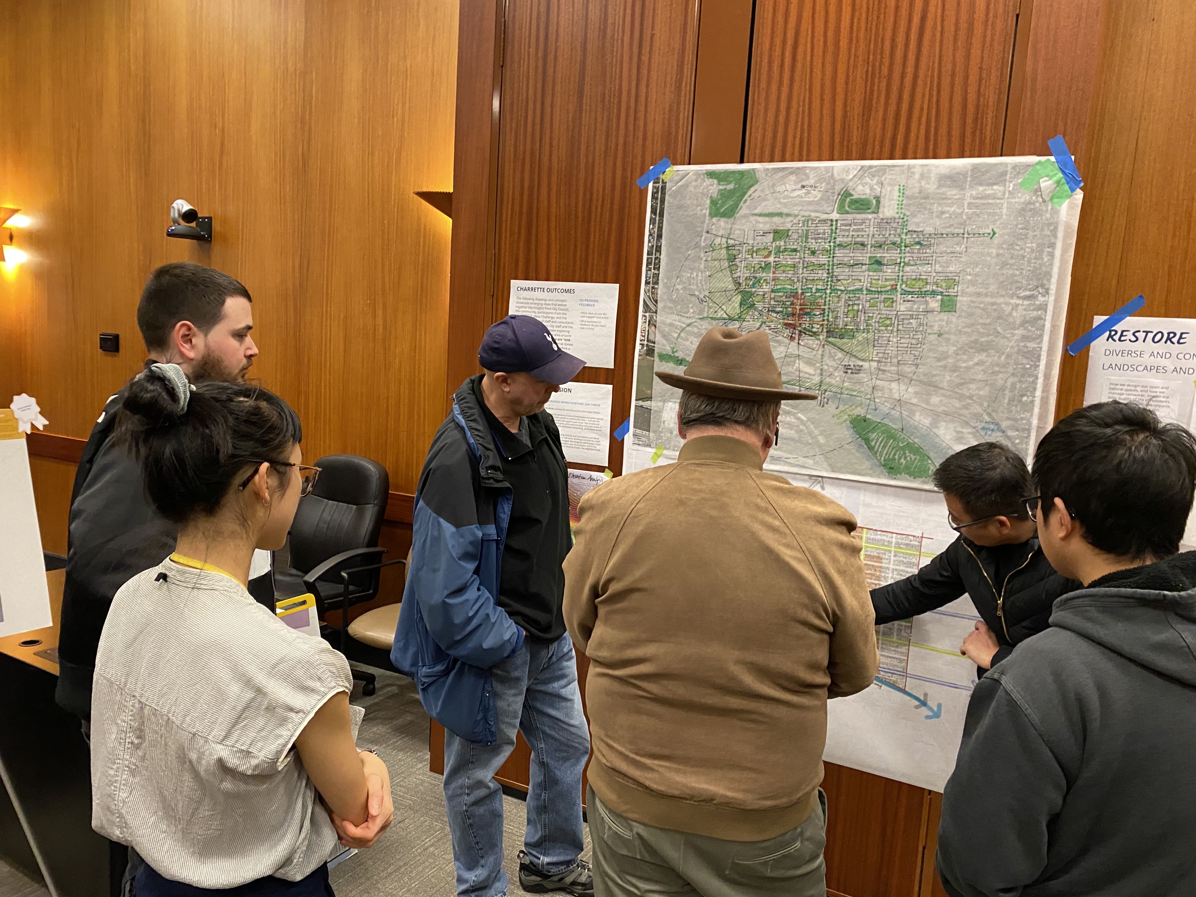 Participants at the March 7 public event look at an illustrated map.